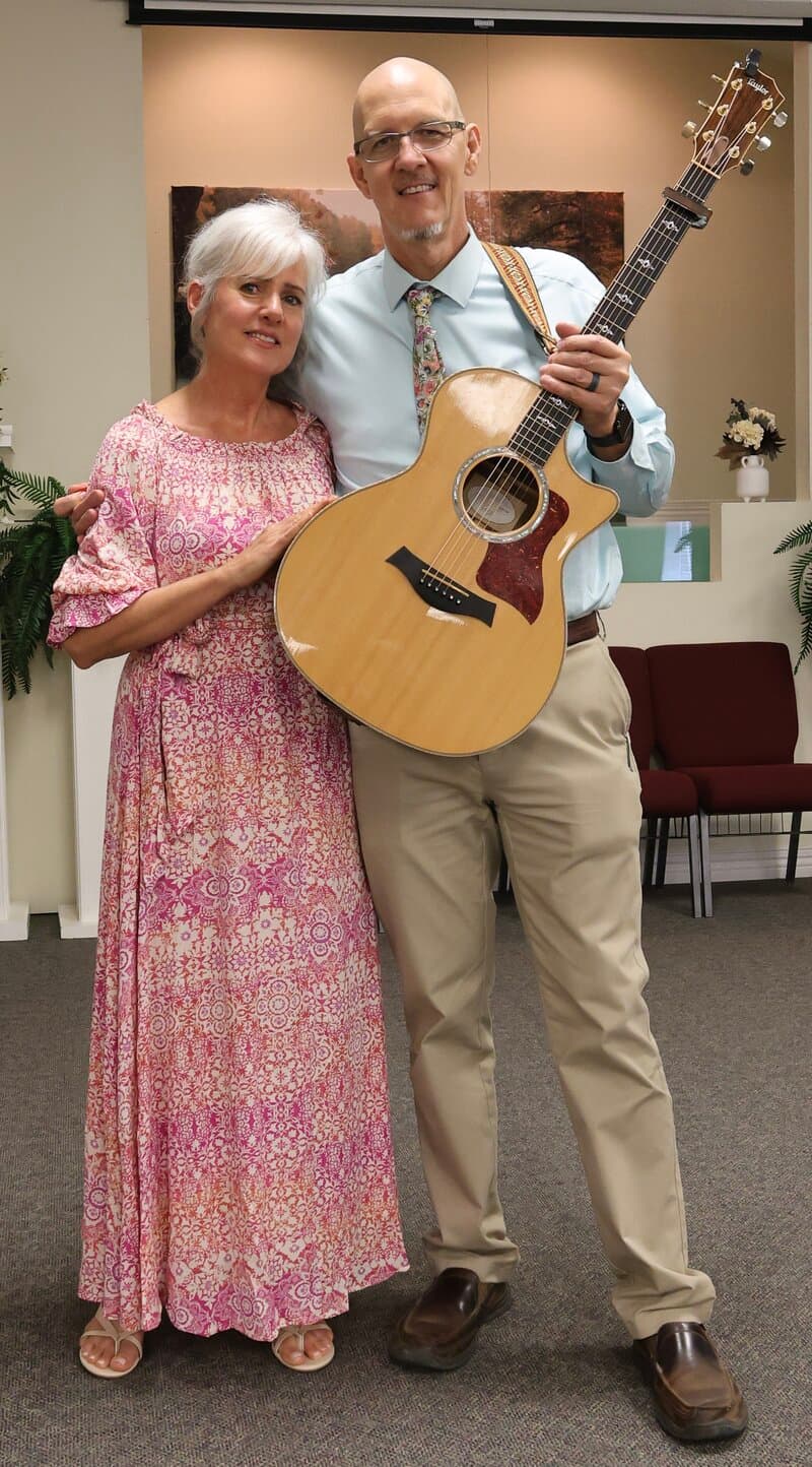 Wylie and Dawna Stevens posing together with guitar