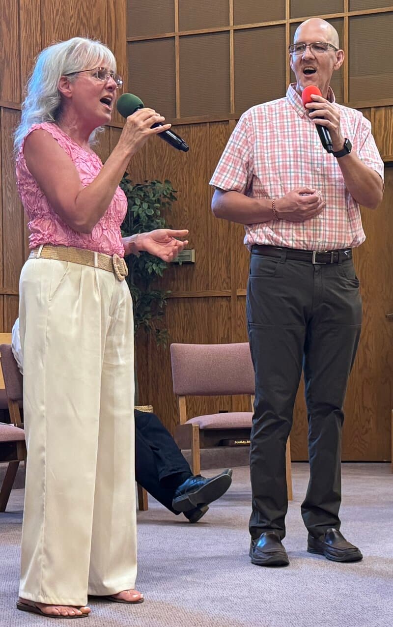Wylie and Dawna singing at microphones