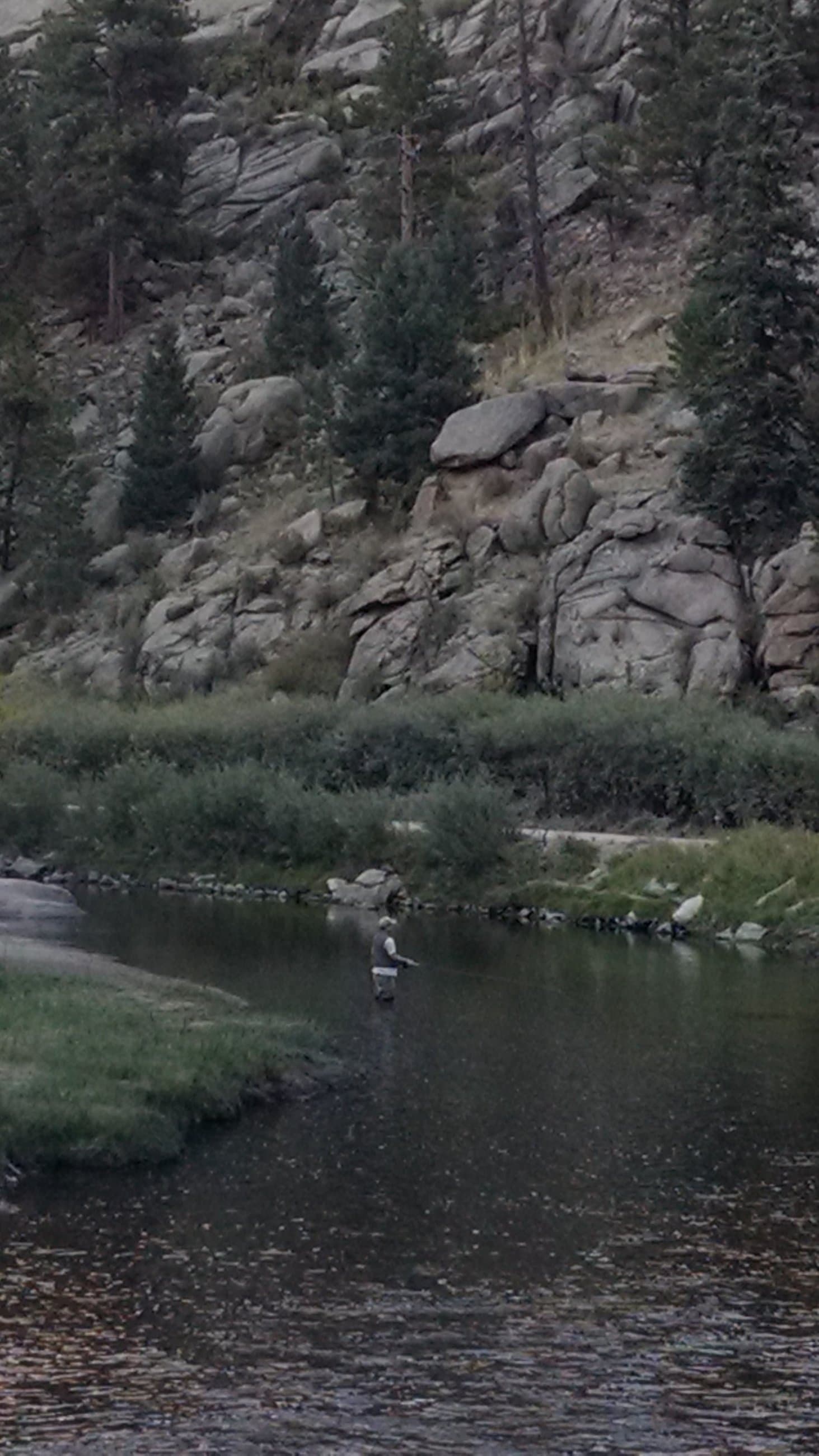 Fisherman in a mountain river