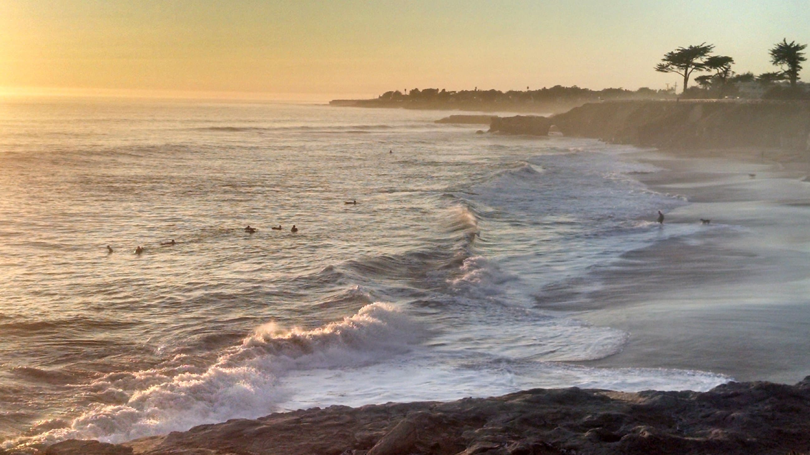Sunset ocean with surfers