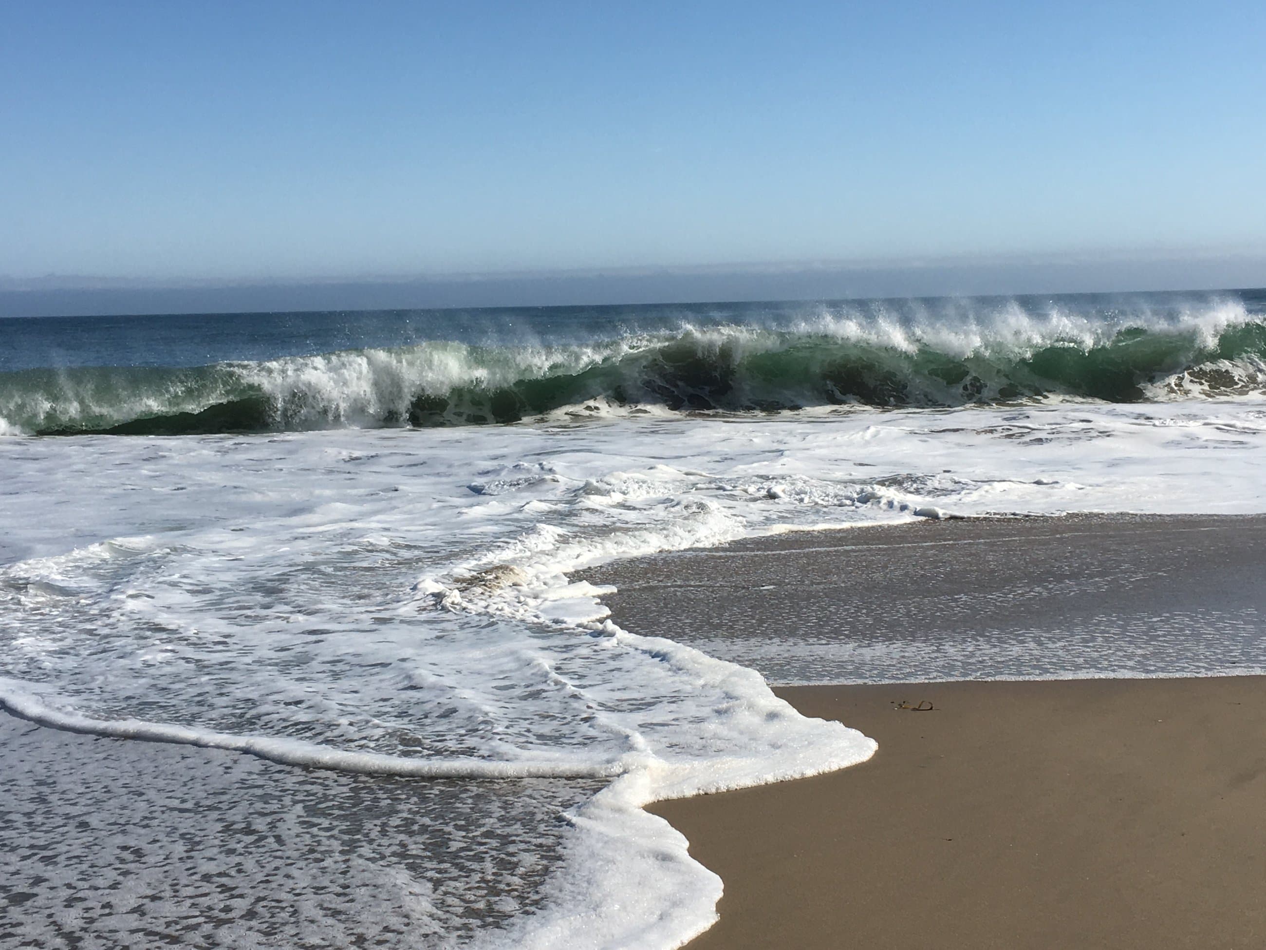 Turquoise ocean waves on beach