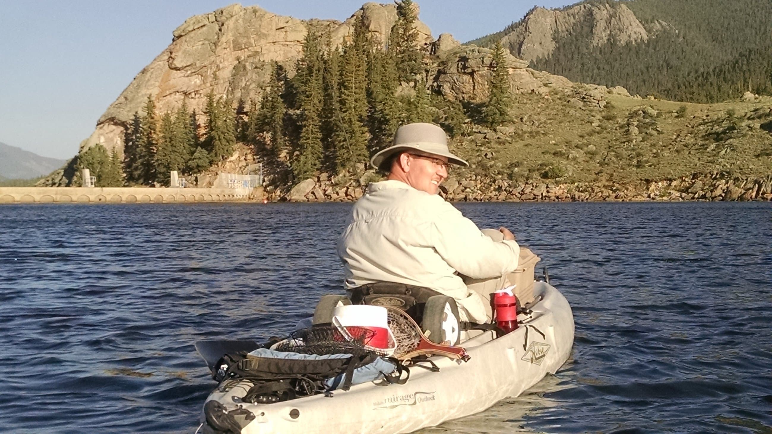 Wylie kayak fishing on a mountain lake